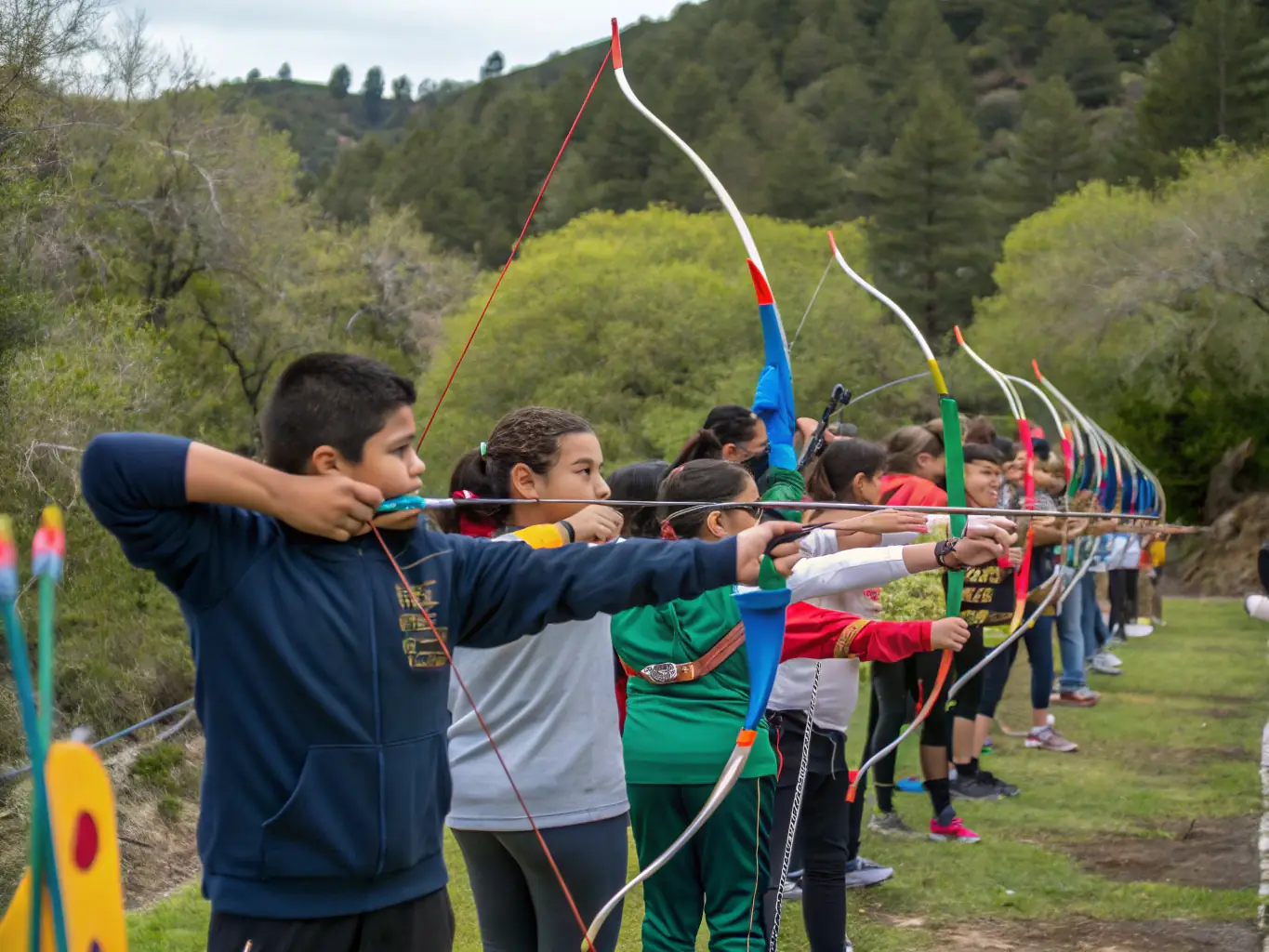 A group of archers participating in an archery workshop, learning new techniques and improving their skills under the guidance of an experienced instructor.